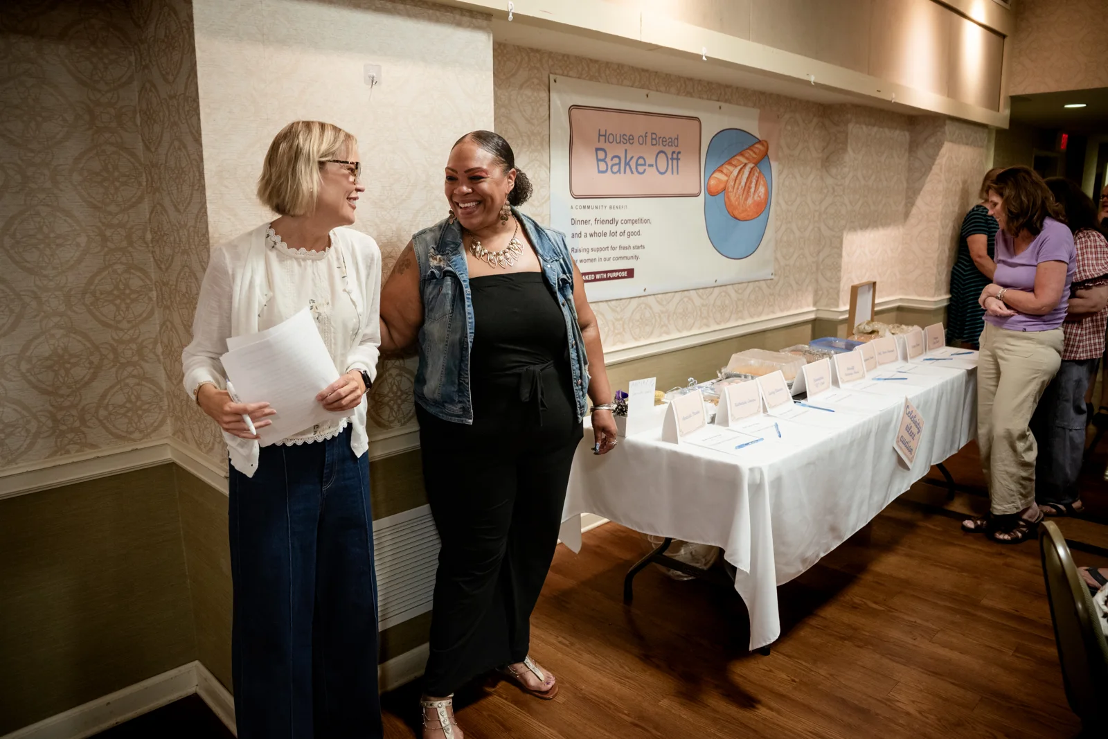 Guests beside the baked-goods display at the House of Bread Bake-Off