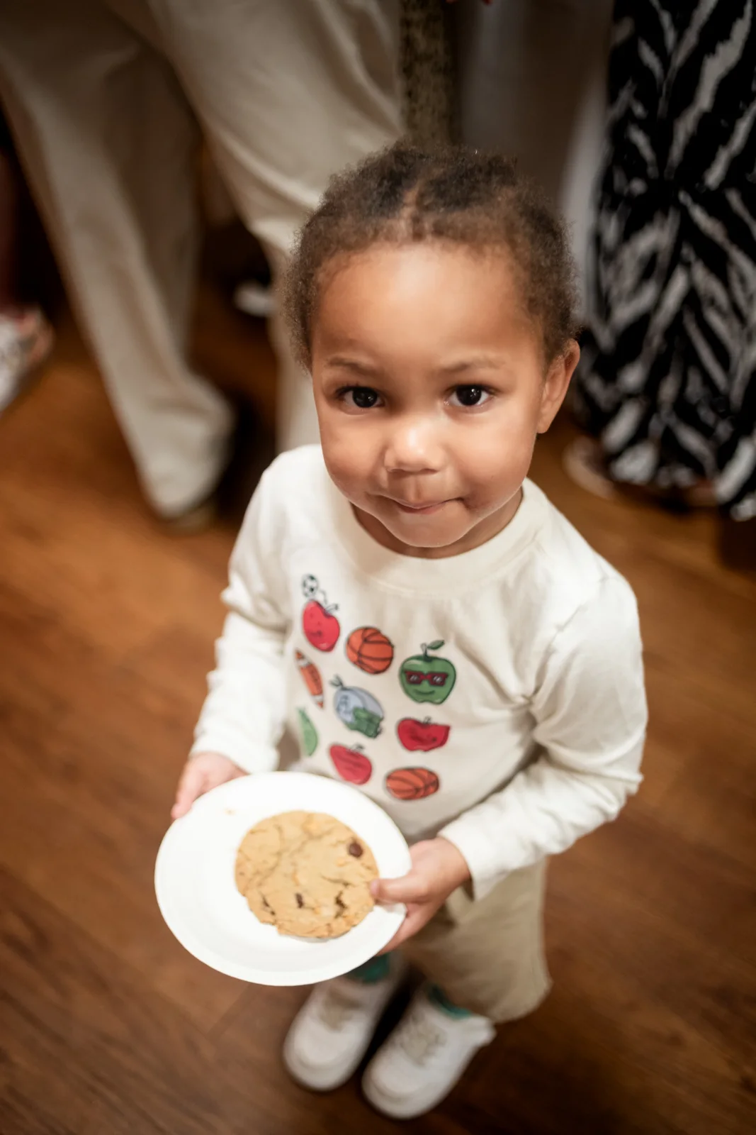 A young guest holds a cookie at the Bake-Off